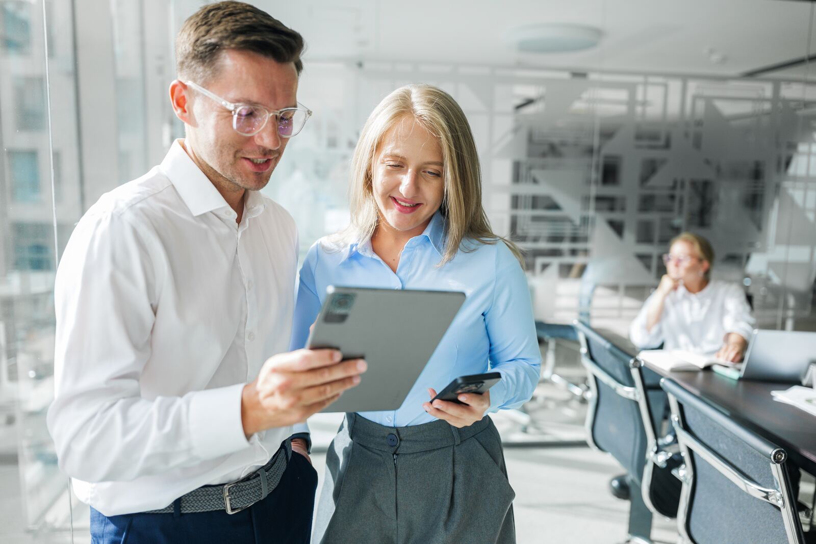Two colleagues reviewing results together on a tablet