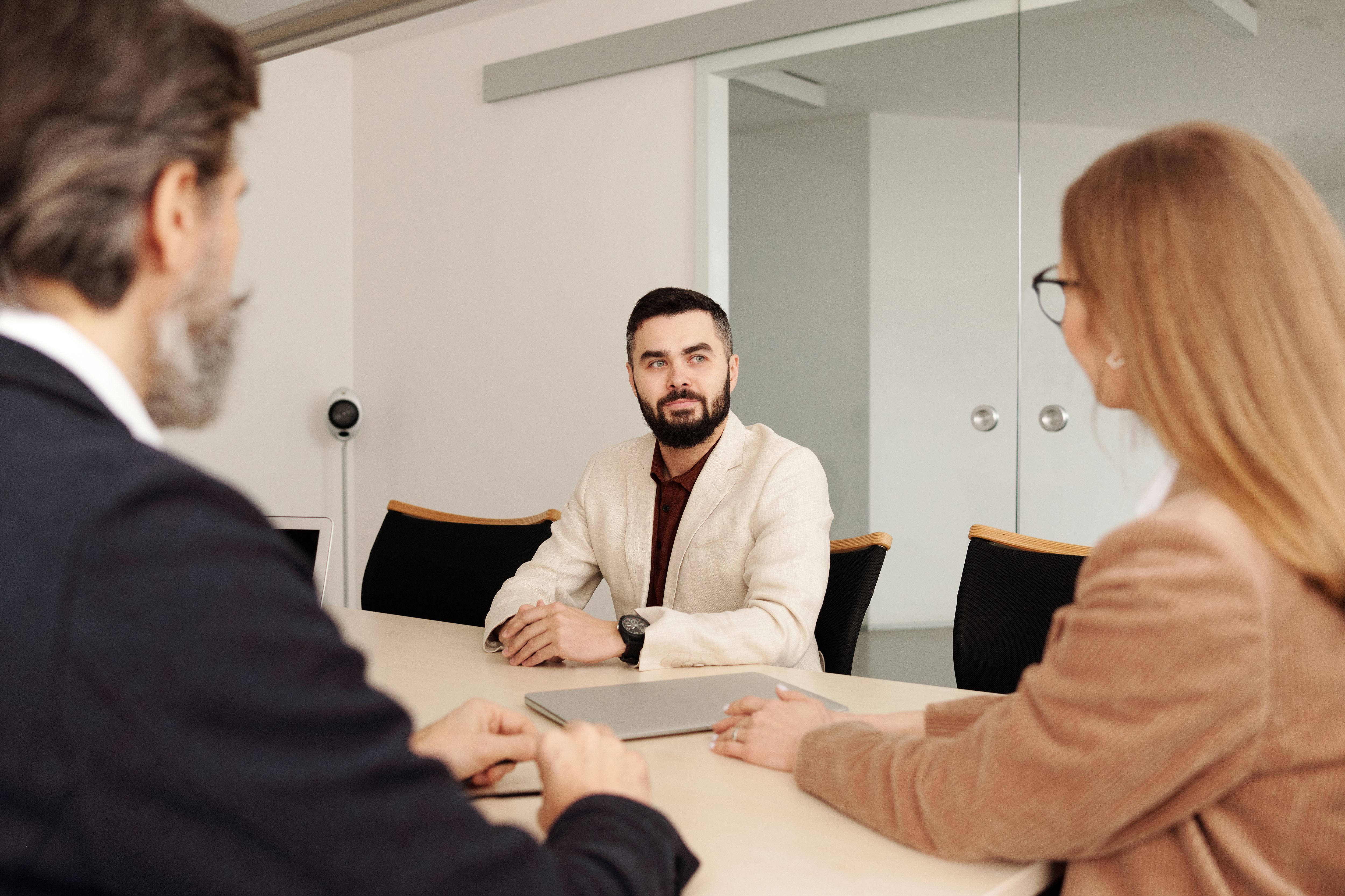 Hiring panel conducting a structured interview with a candidate in a conference room